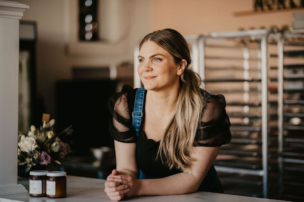 Portrait in a kitchen interior featuring soft lighting and elegant black attire.
