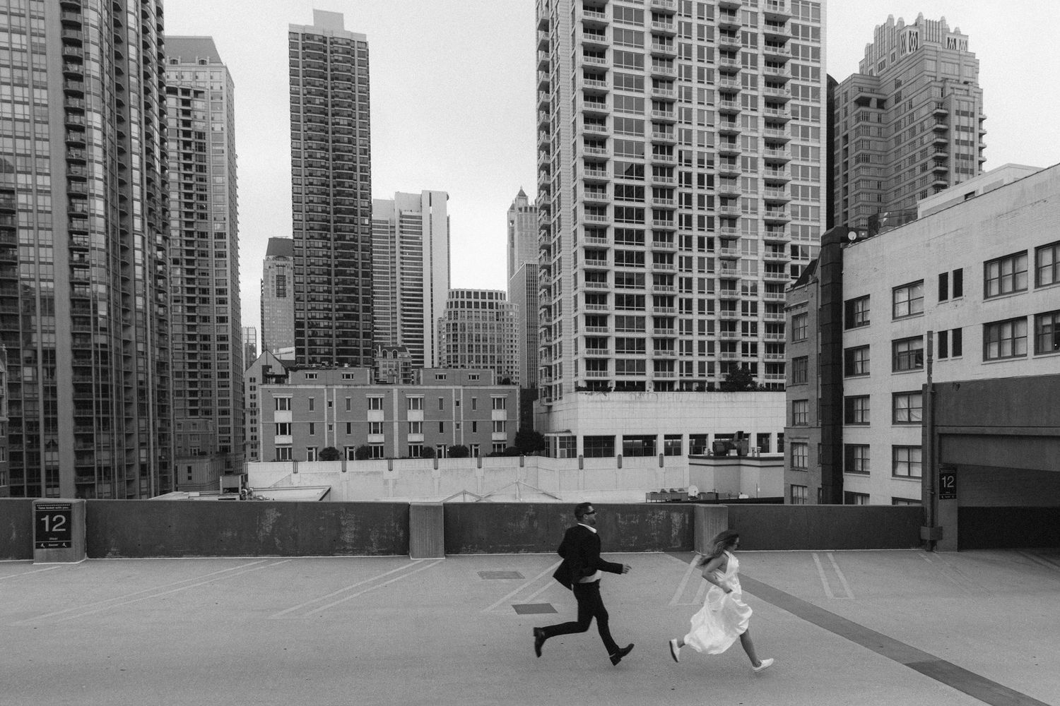 Urban landscape with high-rise buildings and empty courtyard in black and white.