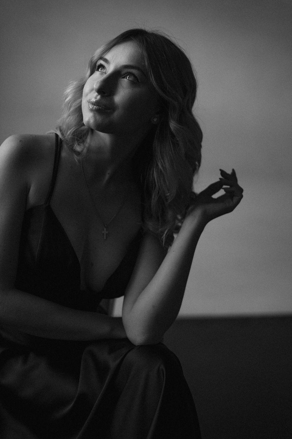 Artistic black and white portrait with elegant pose in evening attire.