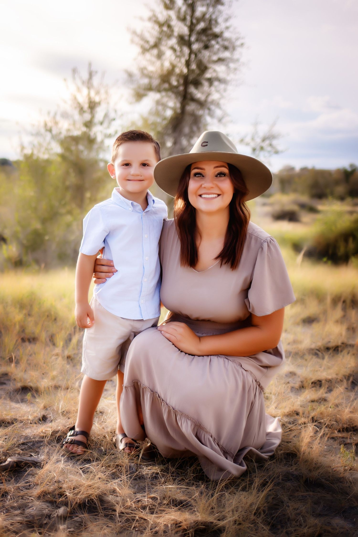 Outdoor family portrait in desert landscape with sun flare and natural scenery.