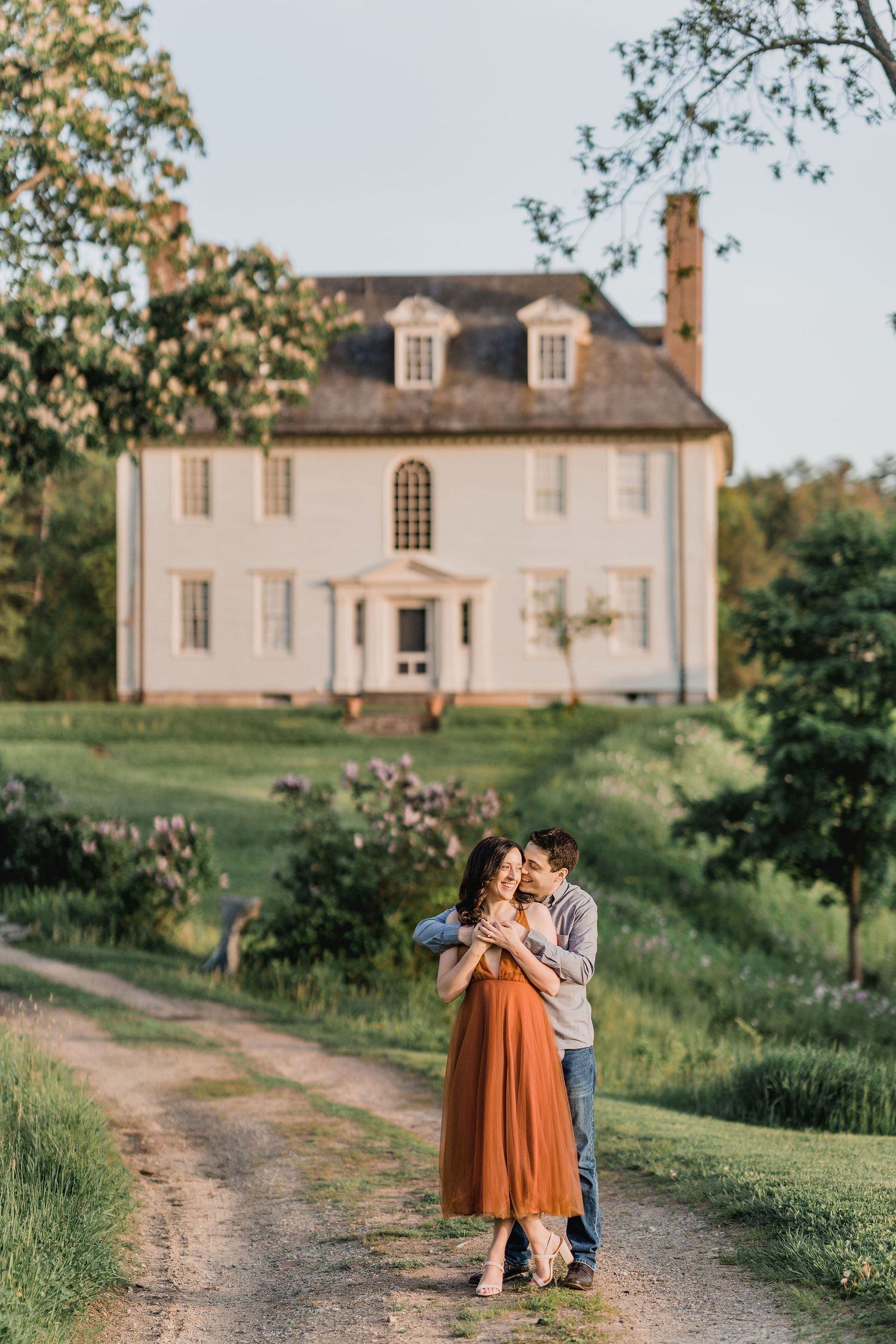 man hugging woman on dirt path leading to Hamilton House in South Berwick, Maine
