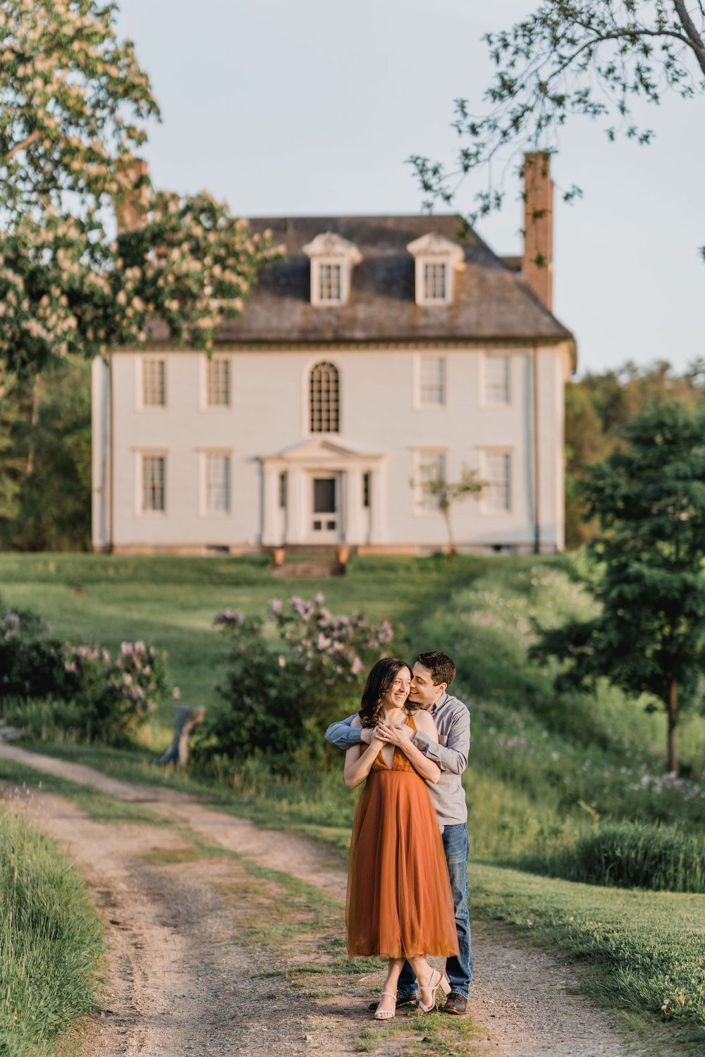 man hugging woman on dirt path leading to Hamilton House in South Berwick, Maine