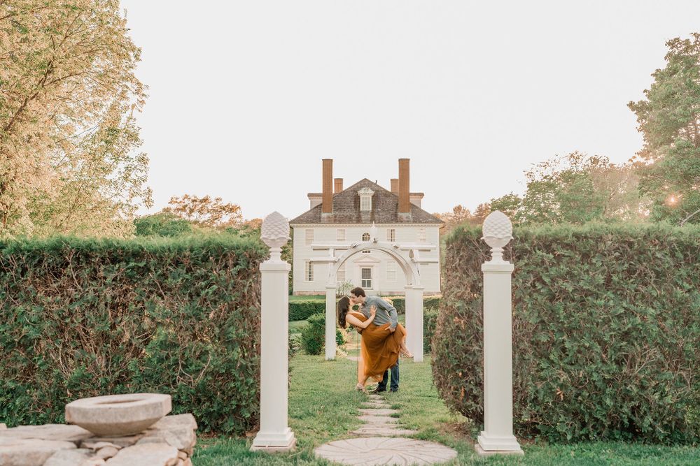 couple kissing in historic gardens of wedding venue in Maine
