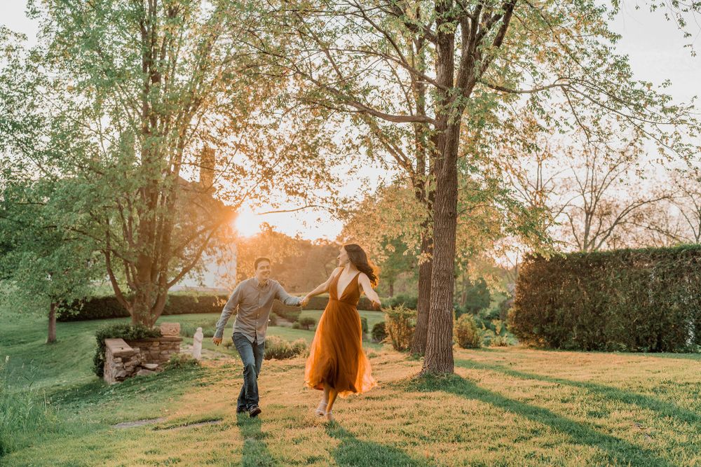 couple running in golden hour sun at Hamilton House wedding venue in southern Maine