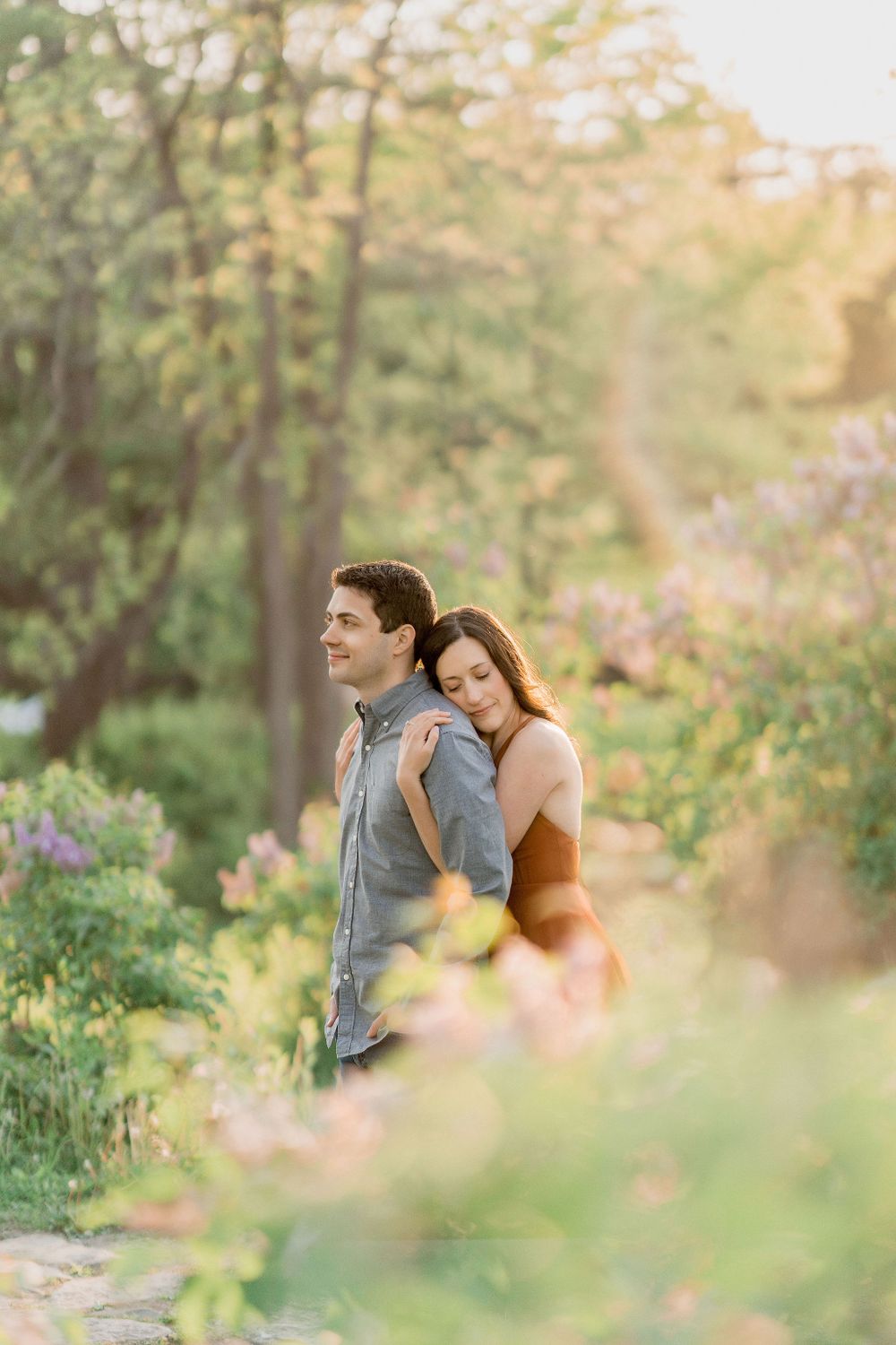woman leaning on man's back in trees at Hamilton House historic Maine estate