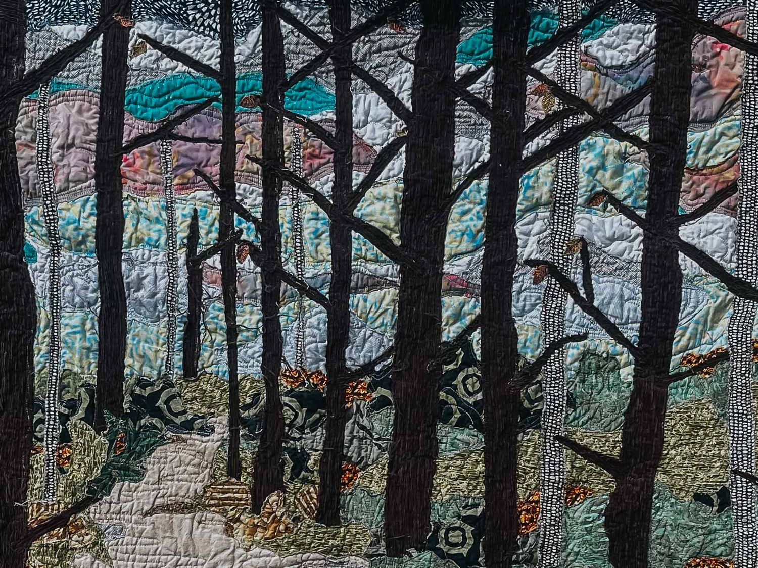 Quilted forest of bare trees with blues and purples in the sky behind.