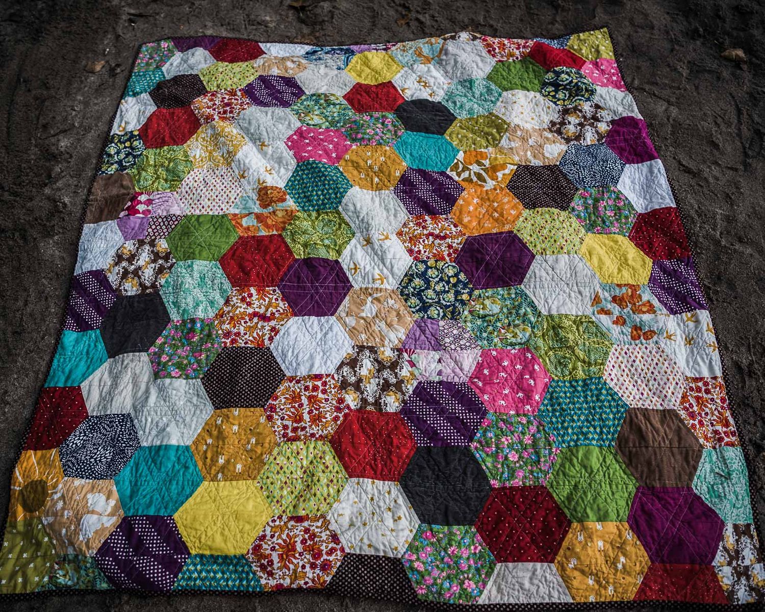 Colourful quilt with hexagons.