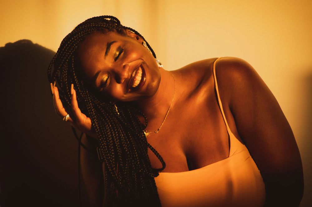 Warm toned portrait with braided hair and natural lighting.