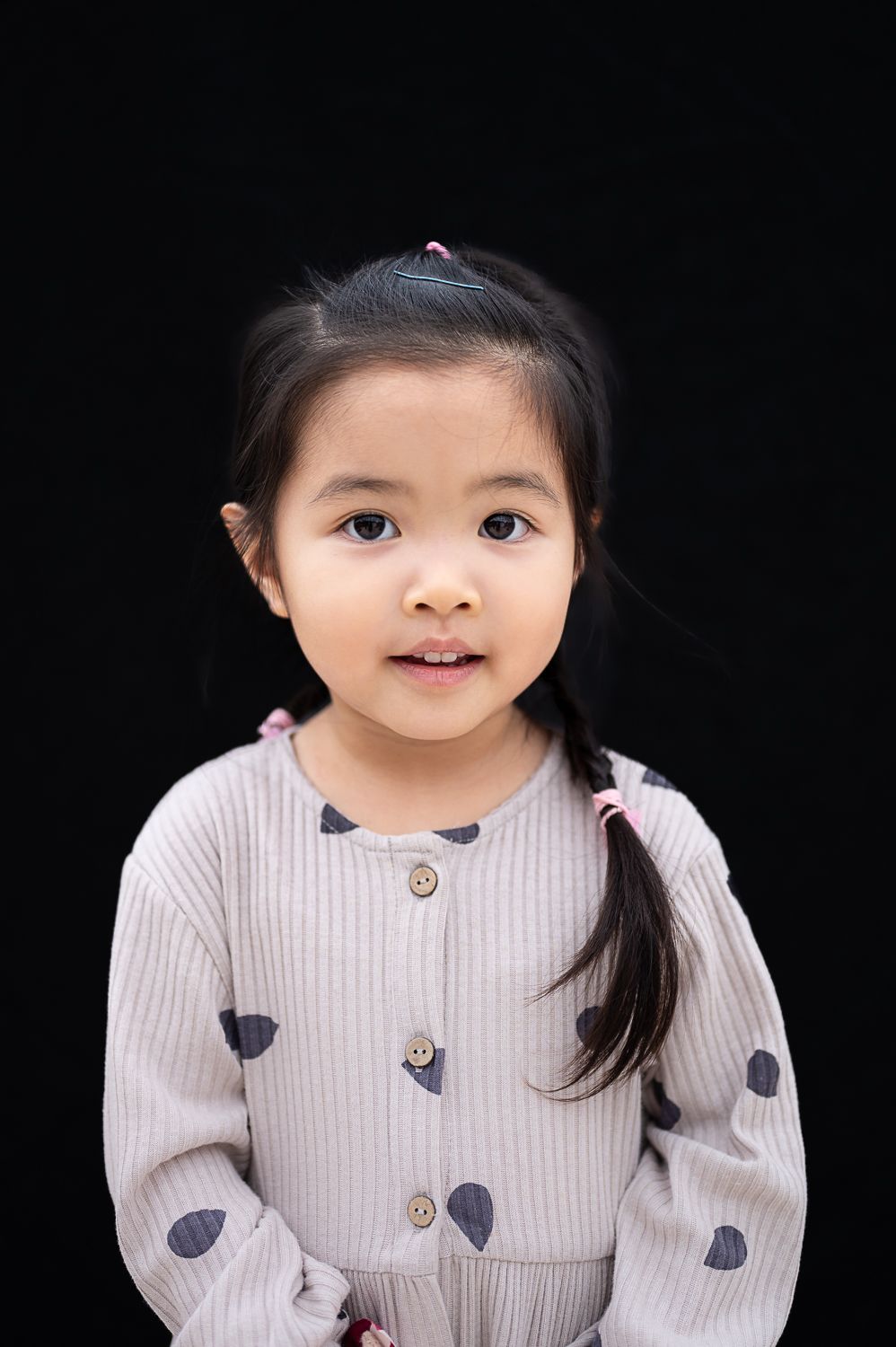 a young chinese girl smiles for a portrait