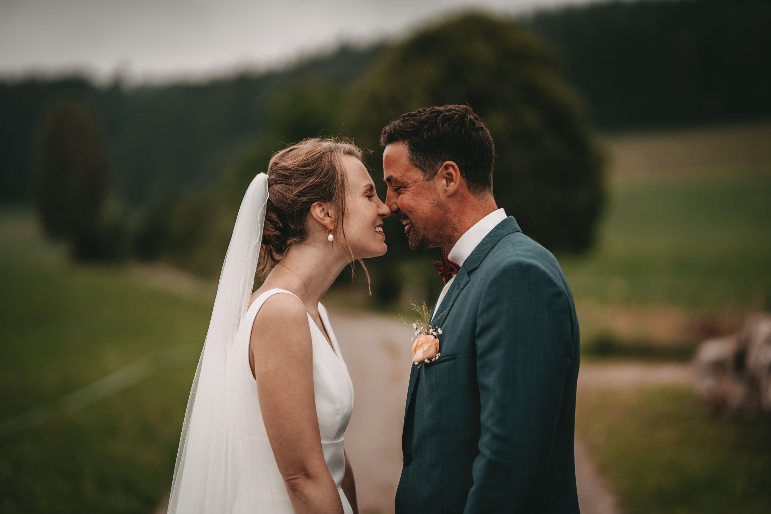 Candid wedding moment captured on a scenic mountain trail.