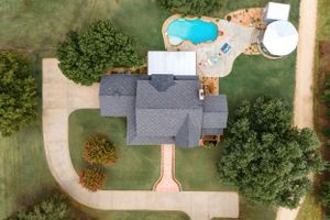 aerial view overhead looking down on large home with pool patio outdoor entertainment area