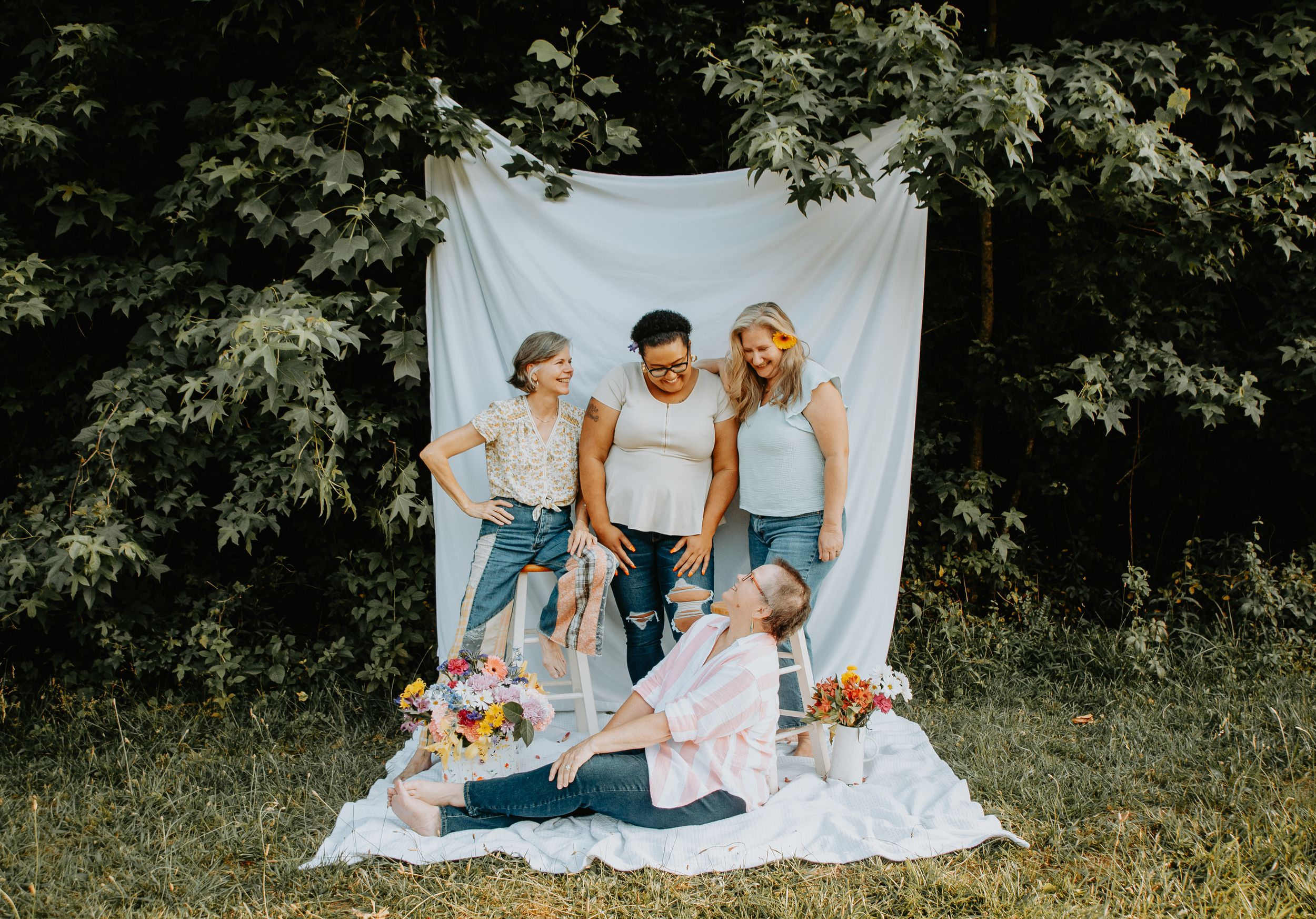 Showing support for breast cancer awareness through pink-themed clothing, ribbons, flowers, and group unity during a photo session