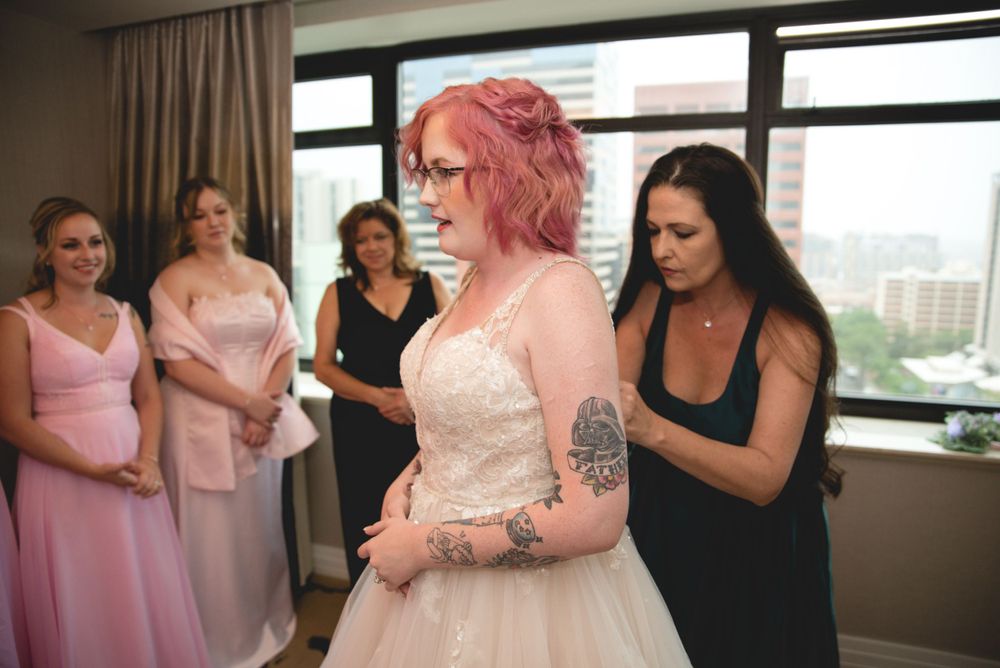 A wedding dress being adjusted during final preparations.