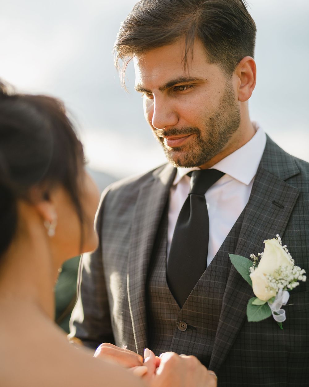 Close up of wedding couple sharing an intimate moment with mountain scenery.