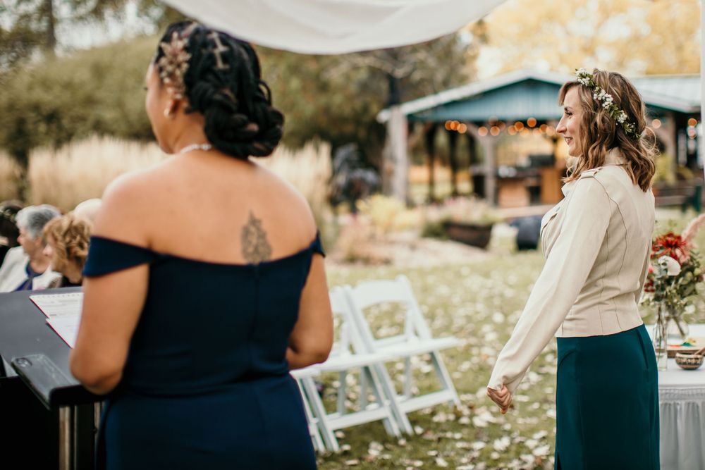 Wedding ceremony preparations with white chairs set up outdoors during autumn.