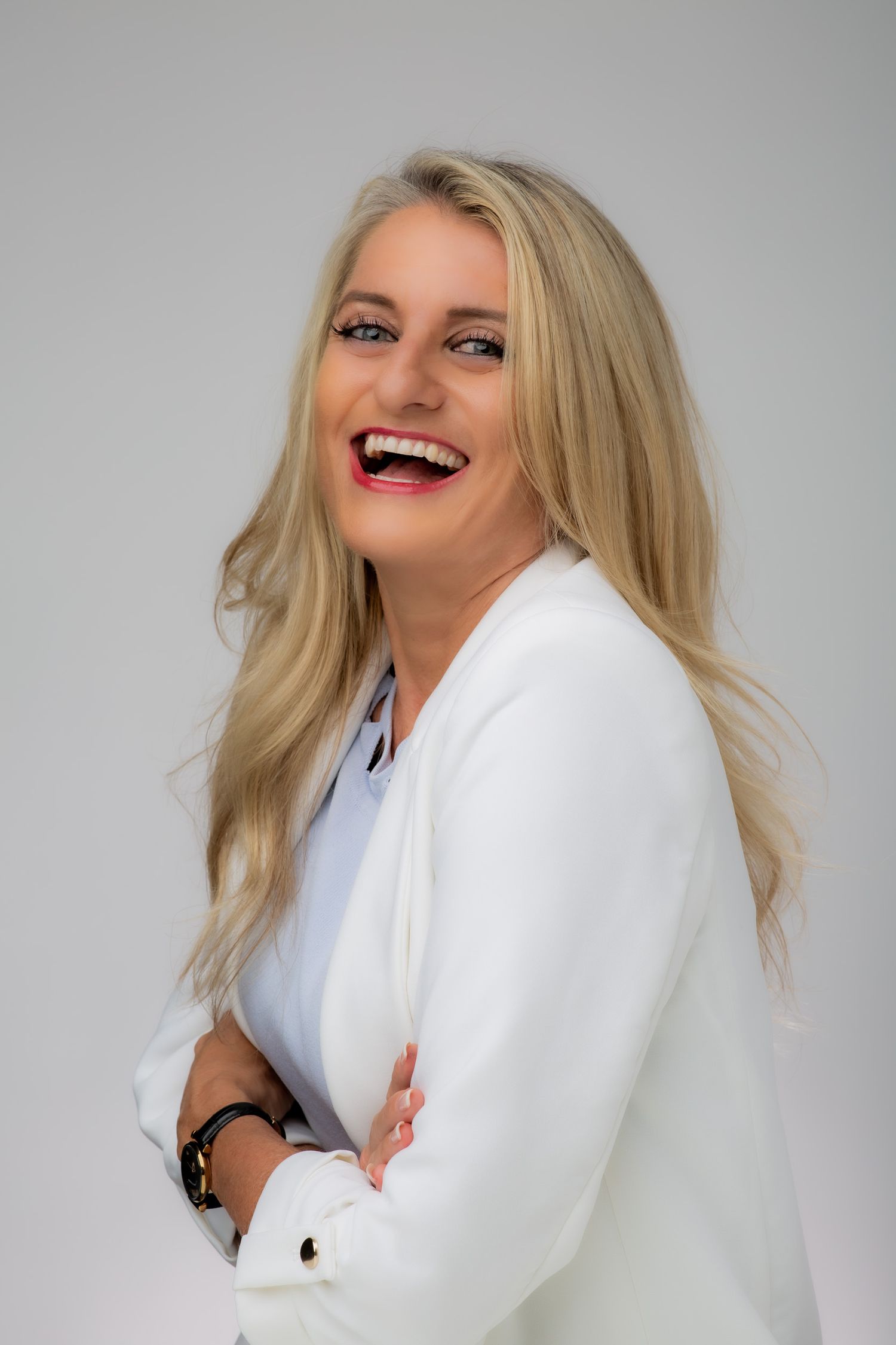 Lucy J. Parker with a big smile during her corporate headshot by Stela McMillan in Dubai.