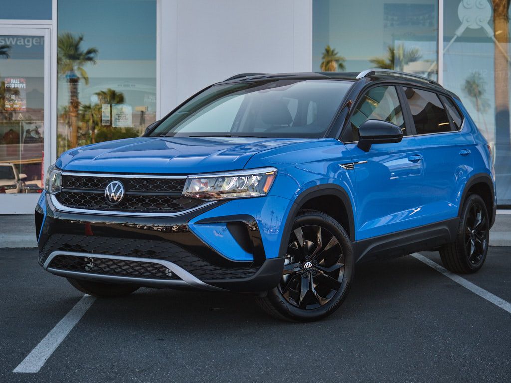 Front three-quarter view of blue Volkswagen Taos with black trim.