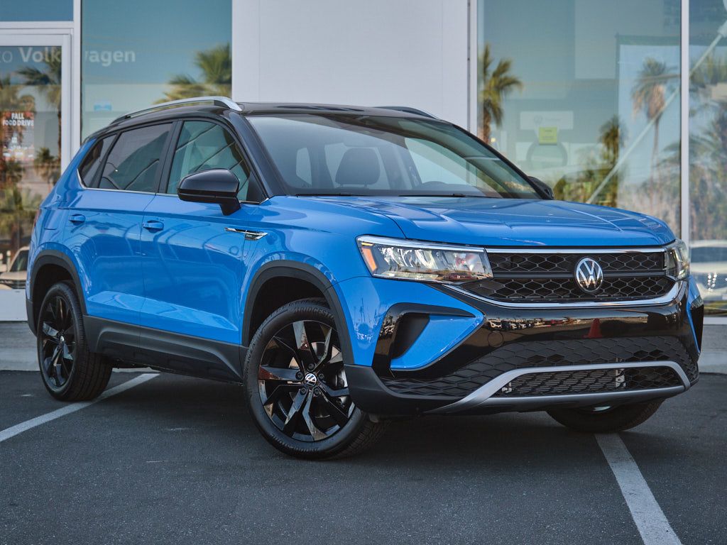 Front view of bright blue Volkswagen Taos SUV with black wheels and trim.