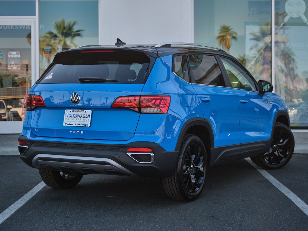 Rear view of blue Volkswagen Taos showing taillight design and black accents.