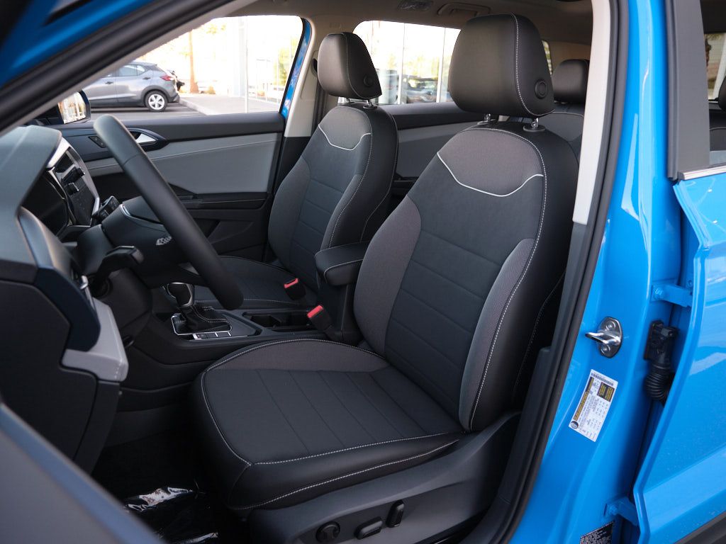 Interior view of a modern vehicle showing black and gray fabric seats with ergonomic design.