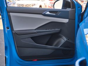 Interior door panel of a blue car showing modern design and power window controls.