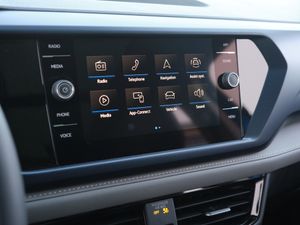 Modern car infotainment system display showing menu icons and controls in a dark interface.