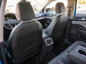 Interior view of car back seats with headrests and rear climate controls visible.