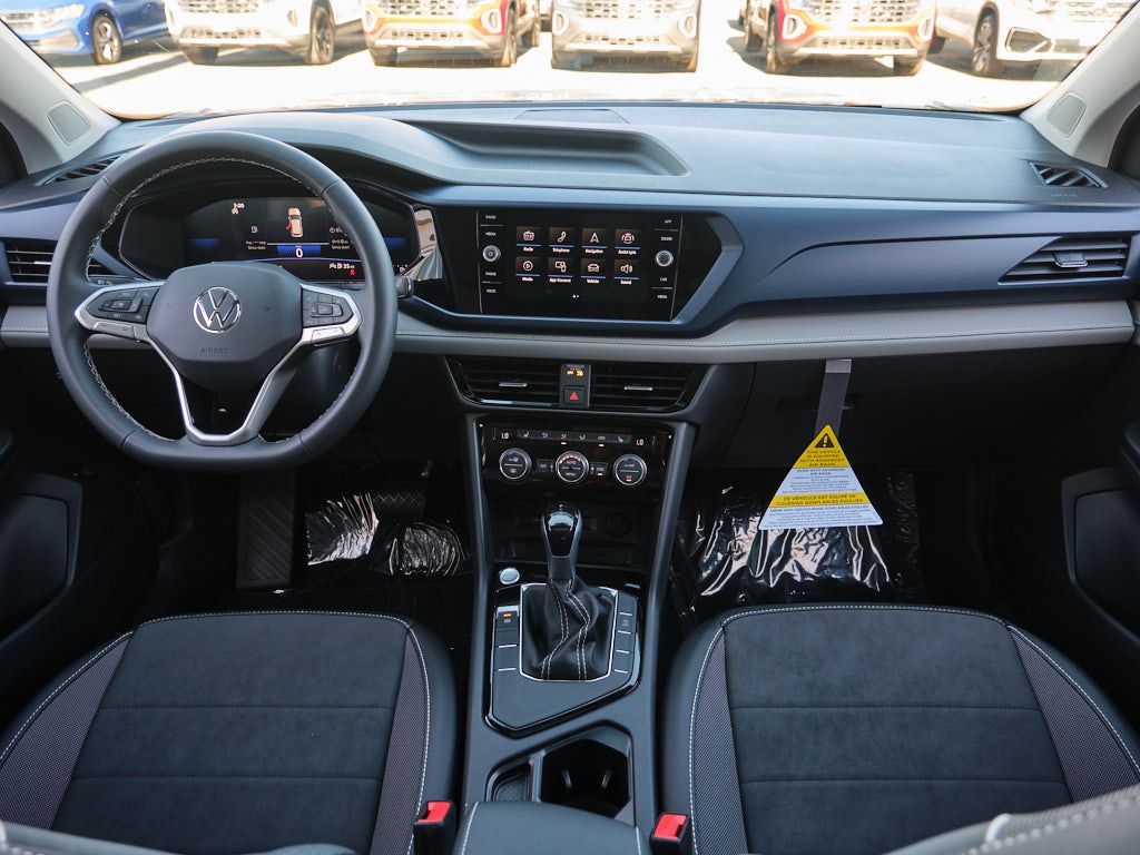 Modern car interior dashboard featuring a digital display screen and automatic transmission in dark gray tones.