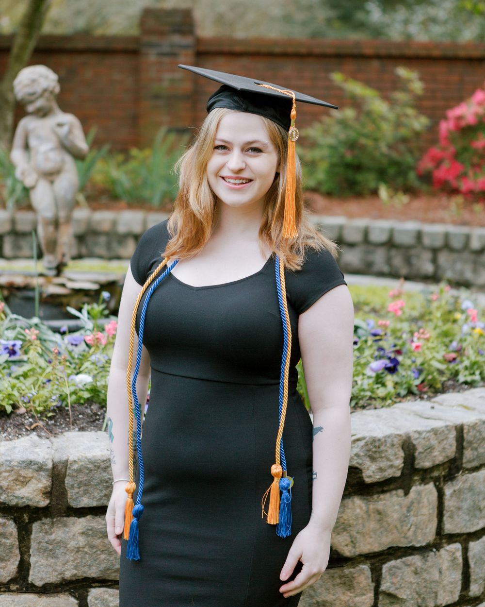Young woman in cap and gown smiles at camera Augusta, GA