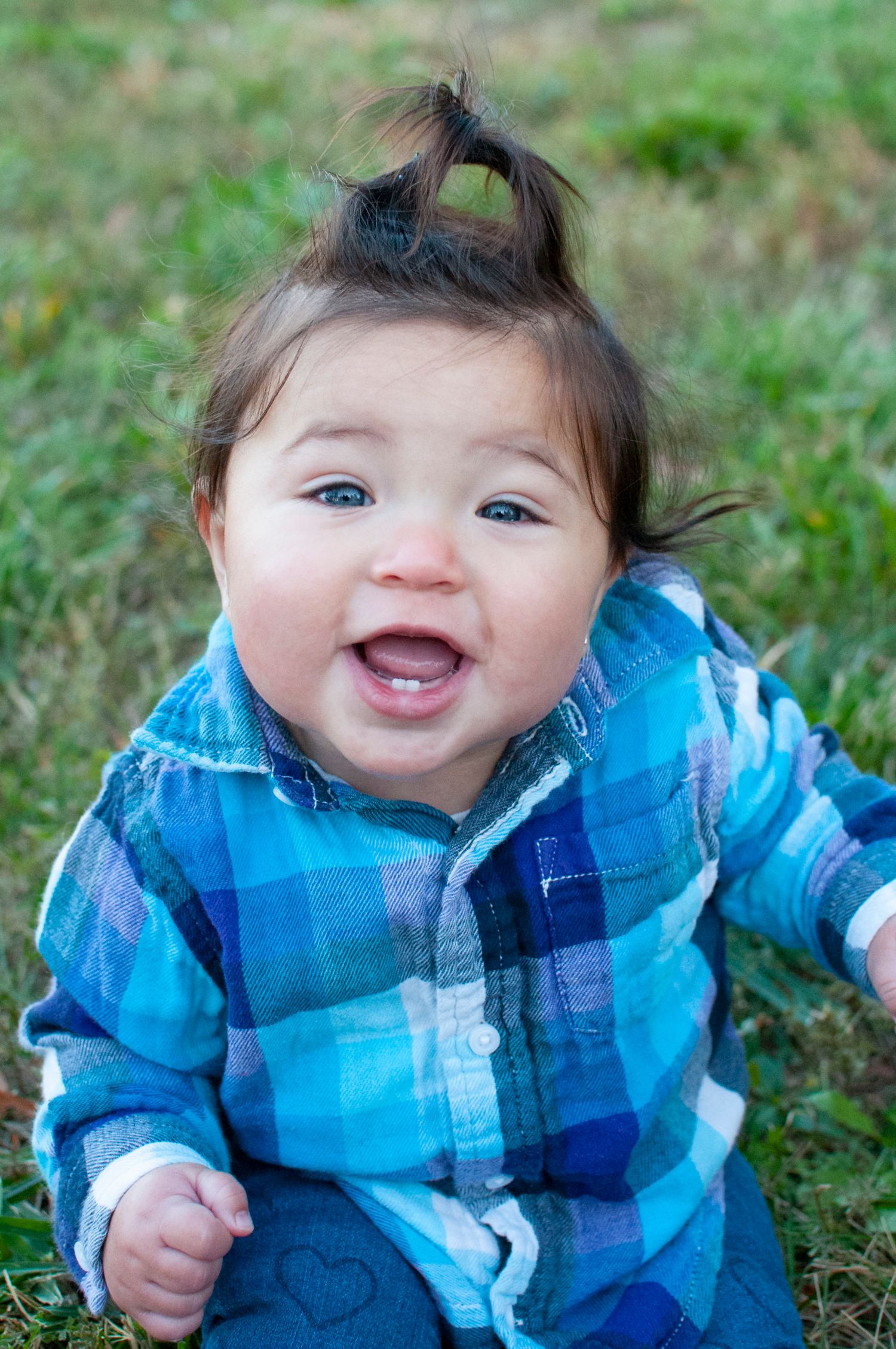 Baby in grass smiling
