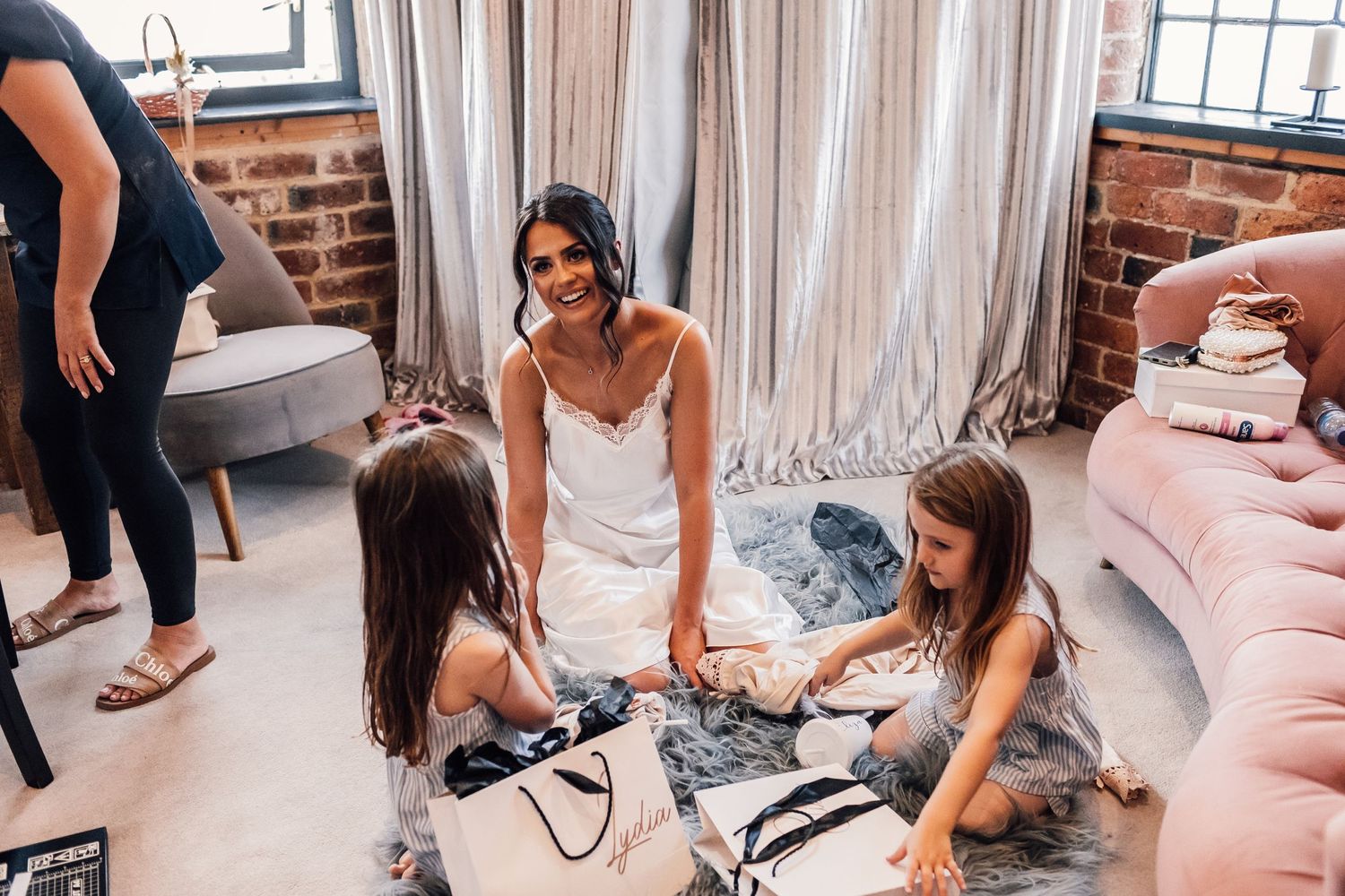 bride smiling while sat on the floor