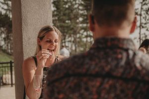 A couple enjoying champagne and conversation during an outdoor celebration.