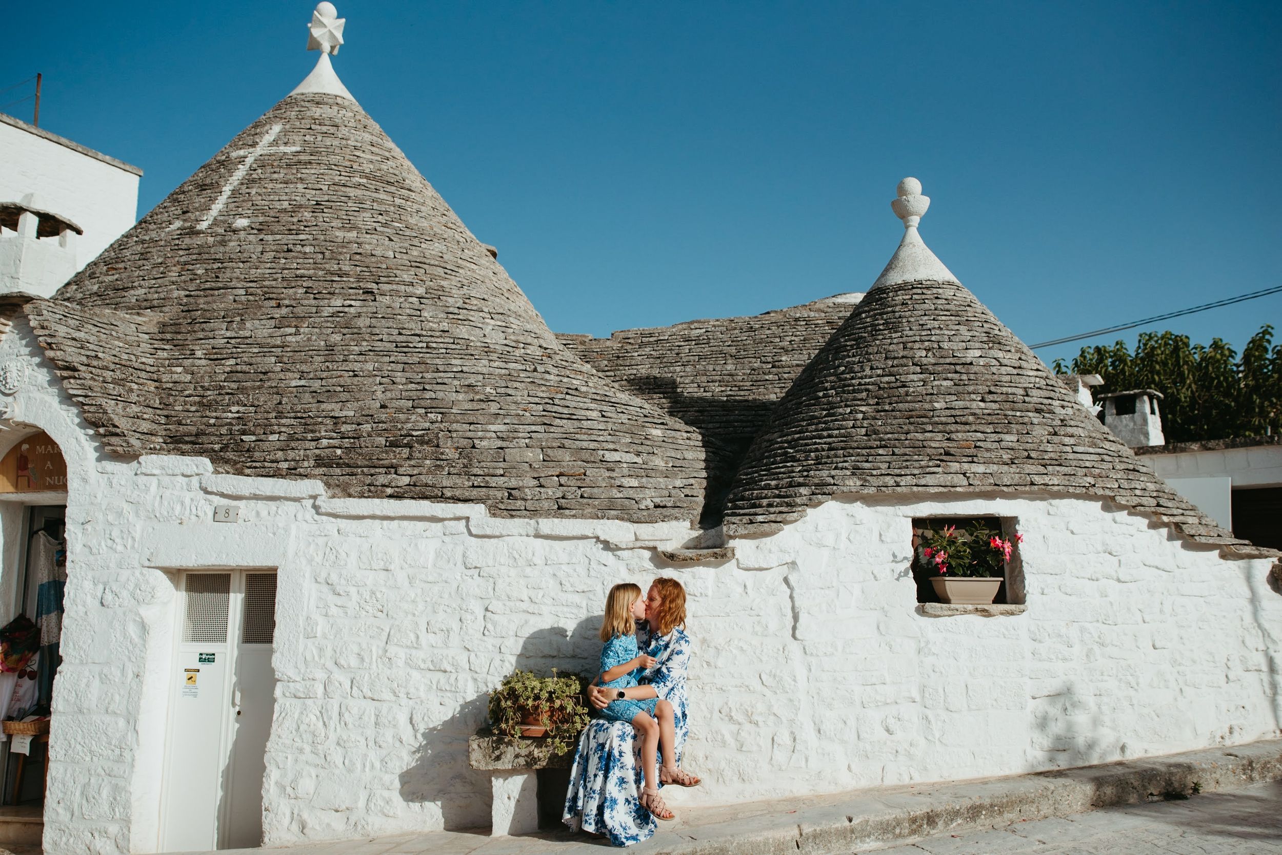 Traditional white trulli houses with conical roofs in Alberobello, Italy.