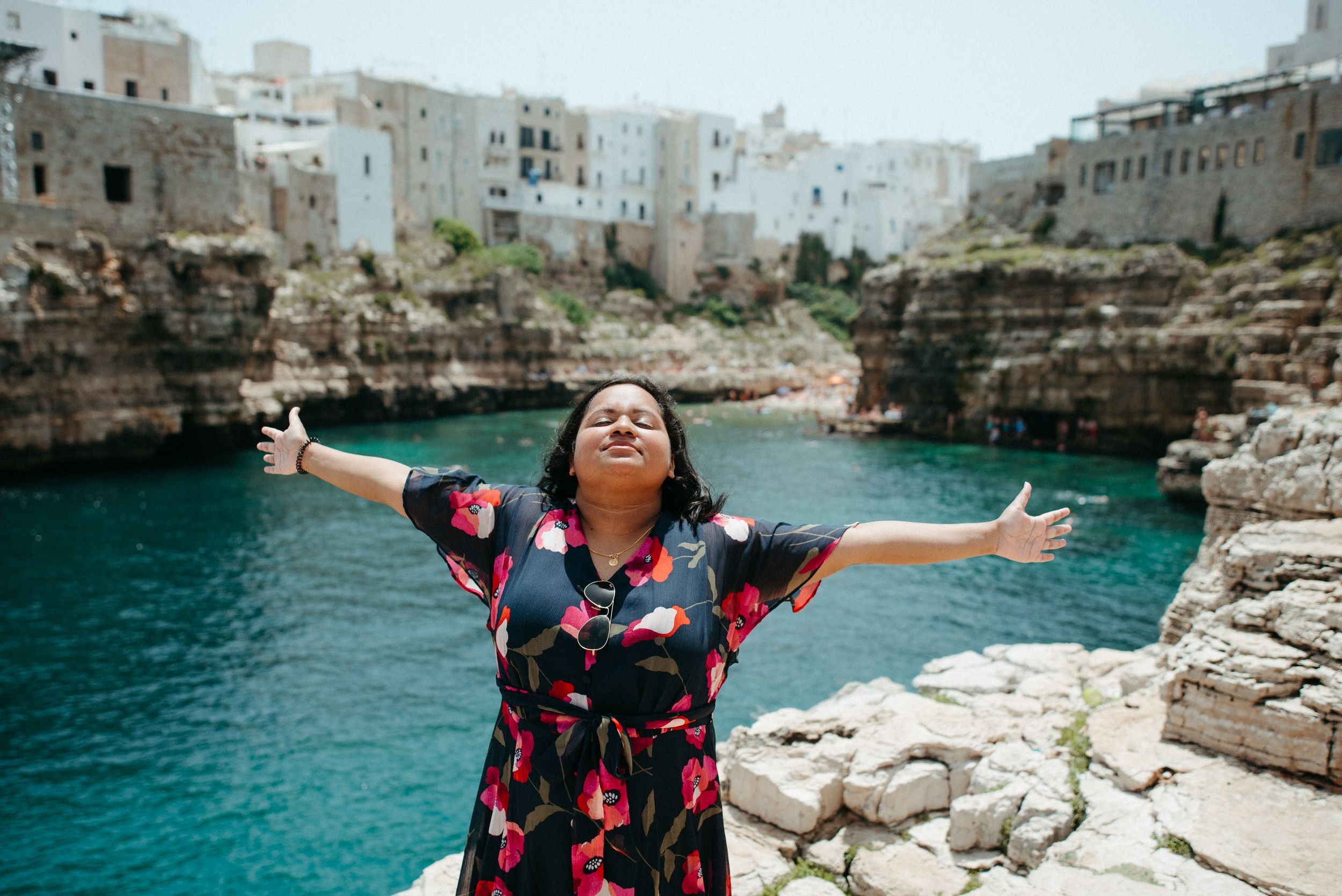 Beautiful coastal landscape of Polignano a Mare with white buildings perched on limestone cliffs.