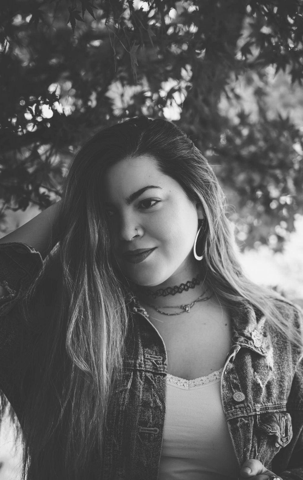 Black and white photo series capturing candid moments with denim jacket and choker necklace.