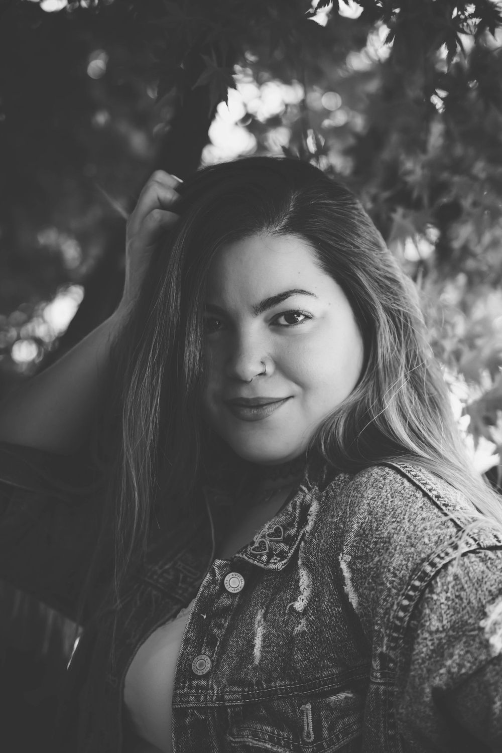 Artistic black and white portrait series showing playful expressions through natural lighting.