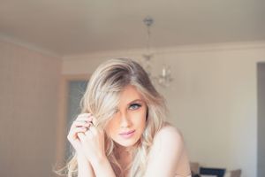 Intimate lifestyle portrait session in a bright interior space with natural lighting.
