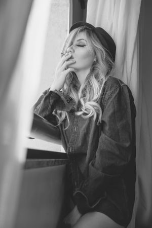 Moody black and white lifestyle portraits featuring someone in denim by a window.