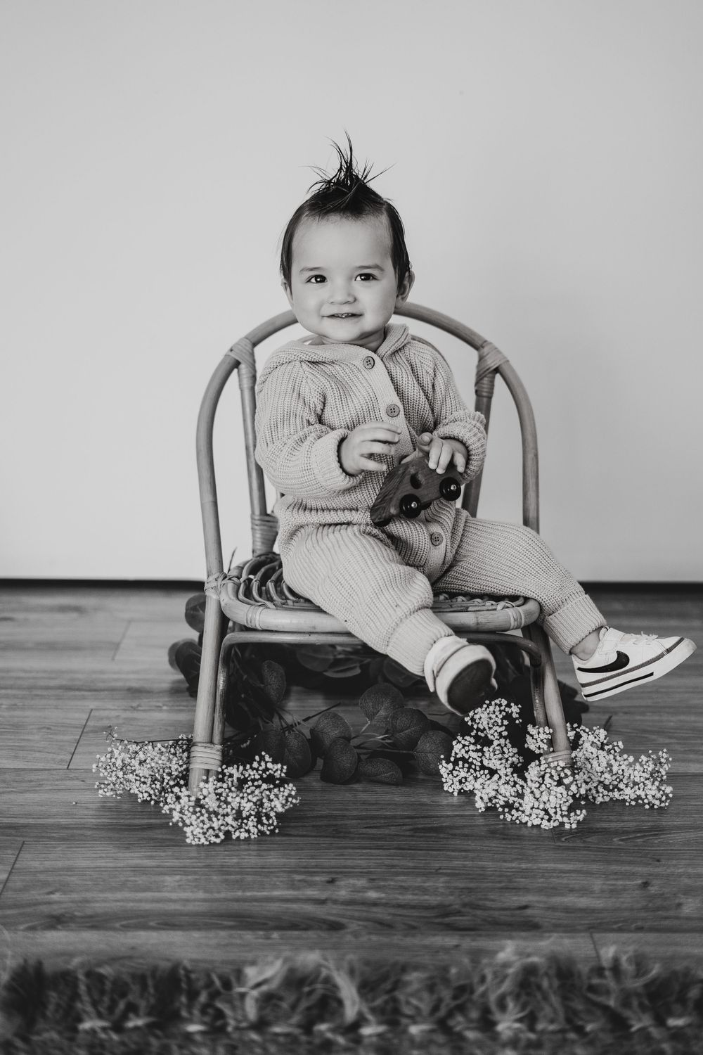 Energetic one-year-old boy photoshoot in Grand Rapids, capturing a happy baby's personality during a milestone photography session.