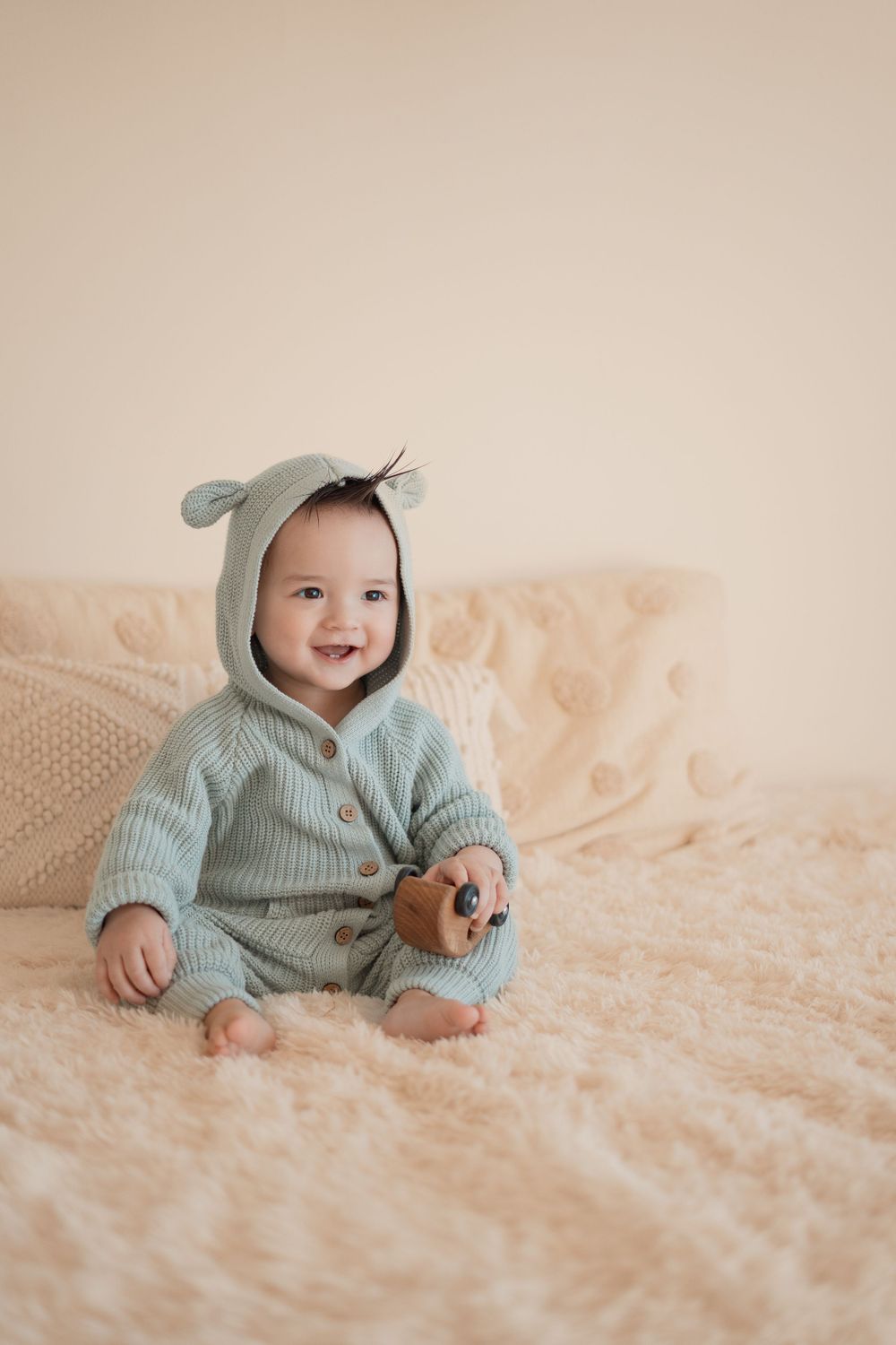 Energetic one-year-old boy photoshoot in Grand Rapids, capturing a happy baby's personality during a milestone photography session.