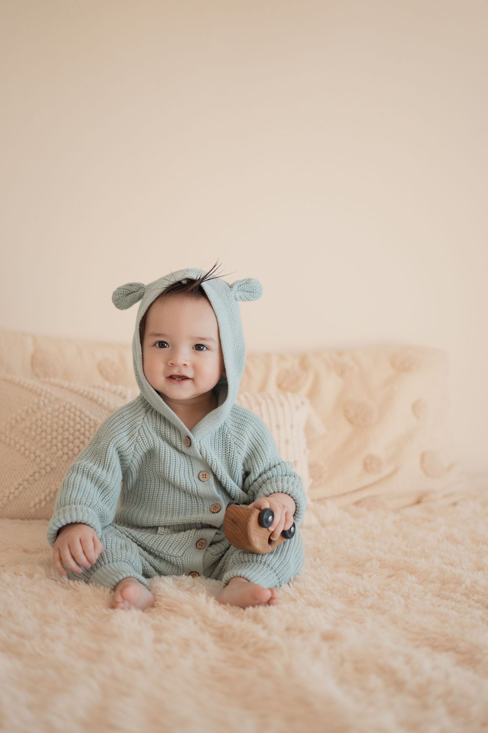 Energetic one-year-old boy photoshoot in Grand Rapids, capturing a happy baby's personality during a milestone photography session.