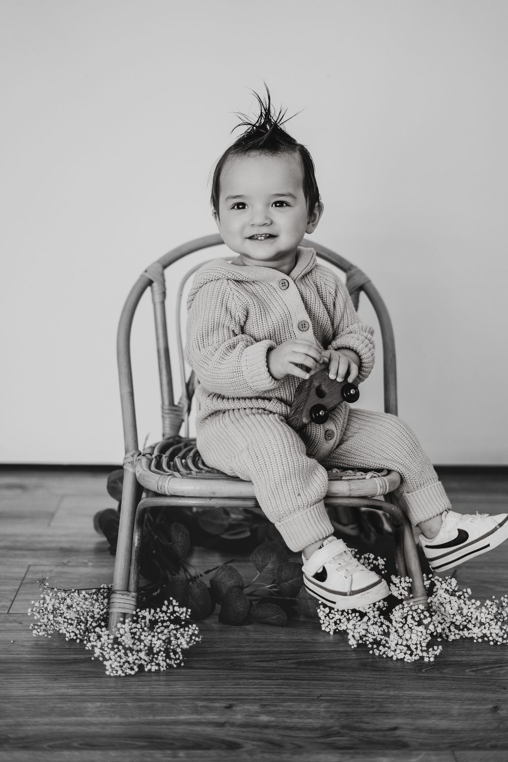 Energetic one-year-old boy photoshoot in Grand Rapids, capturing a happy baby's personality during a milestone photography session.