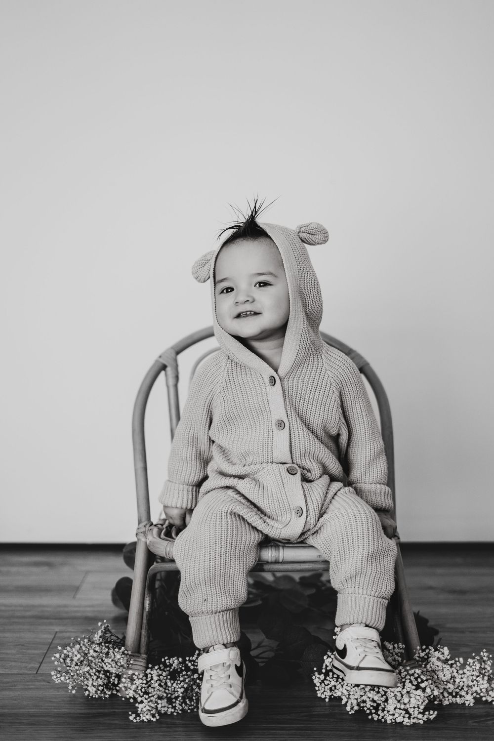 Energetic one-year-old boy photoshoot in Grand Rapids, capturing a happy baby's personality during a milestone photography session.