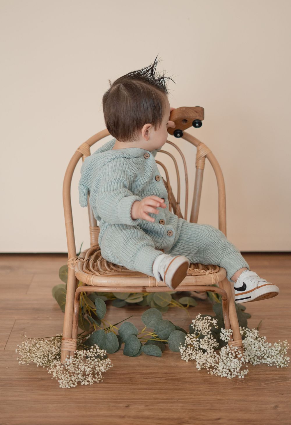 Energetic one-year-old boy photoshoot in Grand Rapids, capturing a happy baby's personality during a milestone photography session.