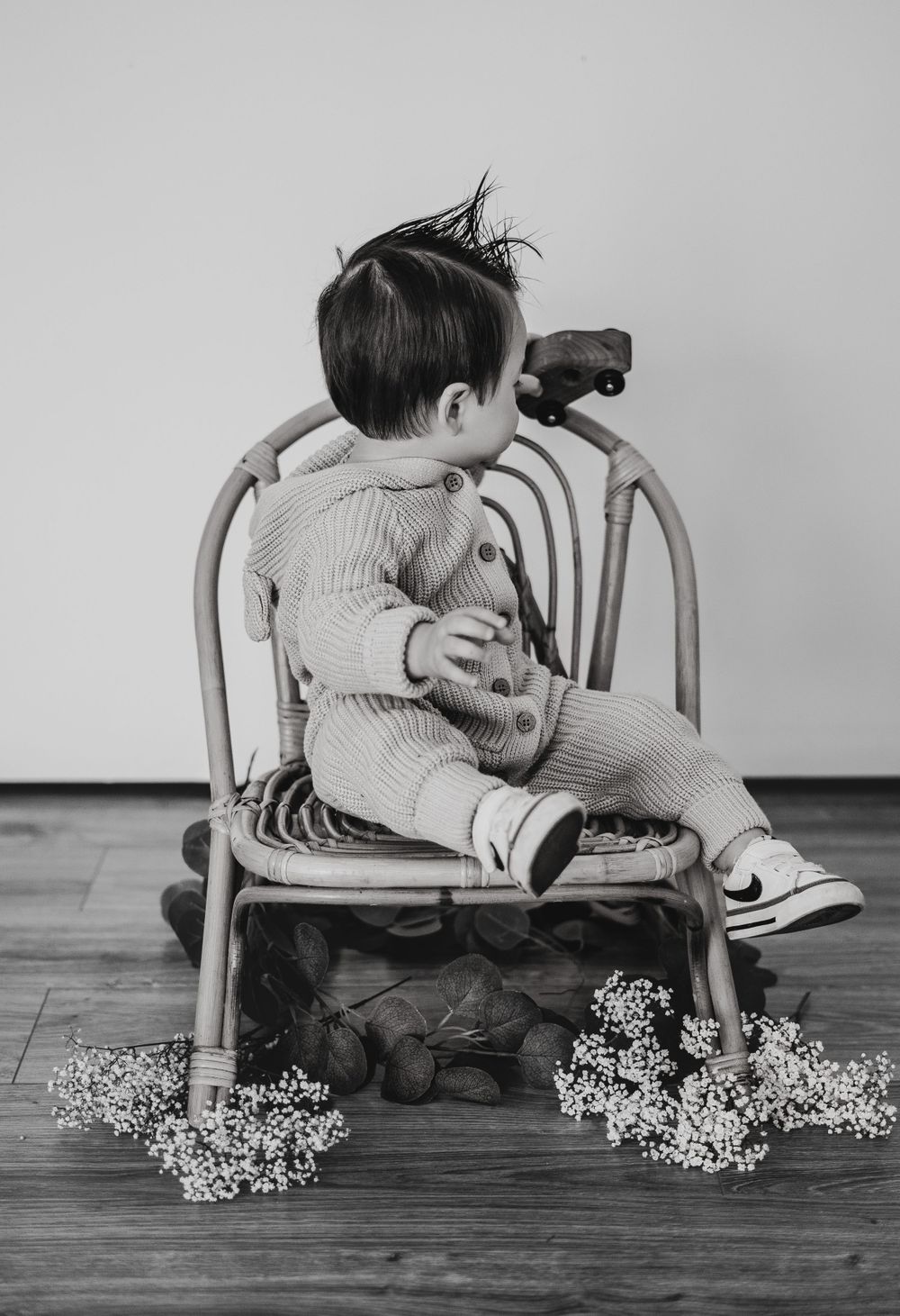 Energetic one-year-old boy photoshoot in Grand Rapids, capturing a happy baby's personality during a milestone photography session.