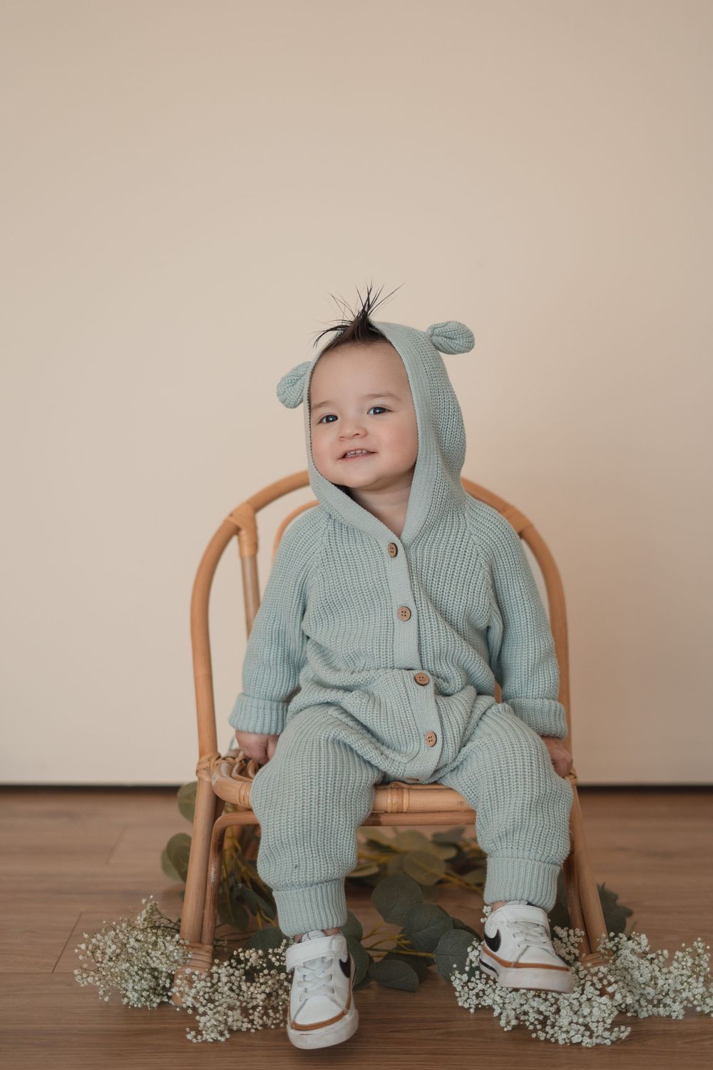 Energetic one-year-old boy photoshoot in Grand Rapids, capturing a happy baby's personality during a milestone photography session.