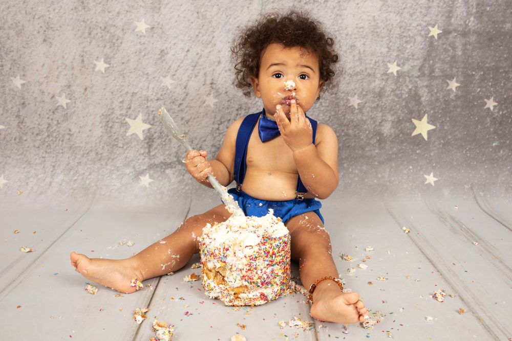 Cake smash, boy enjoying cake and getting messy.