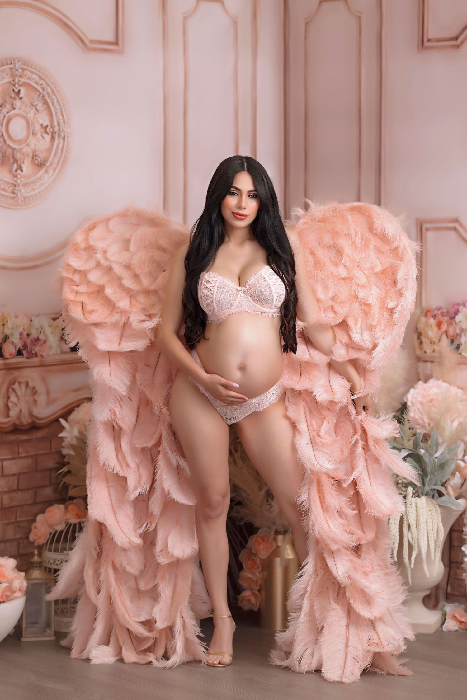 Ethereal portrait with dramatic pink ruffled wings in elegant setting.