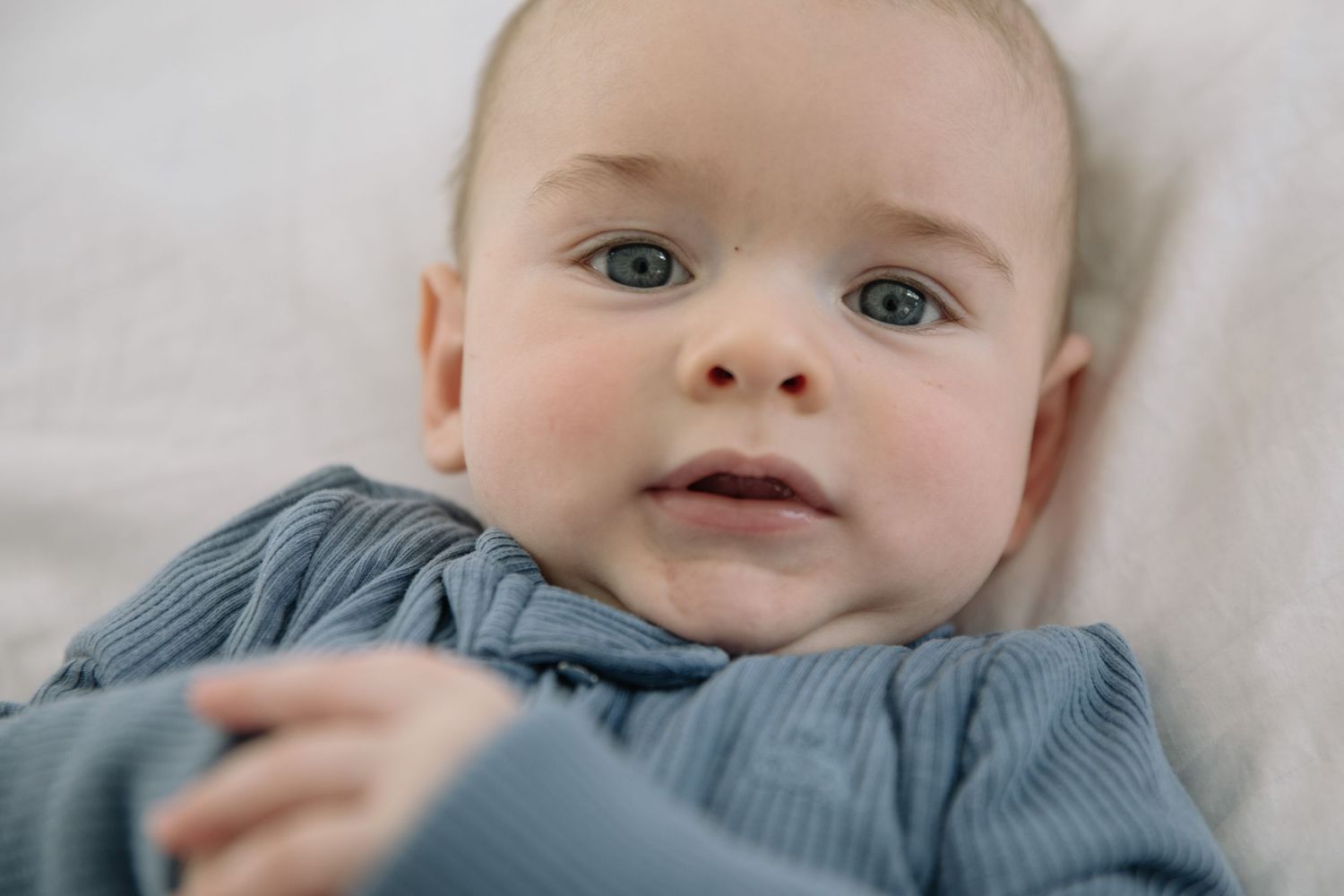 newborn baby boy looking at the camera