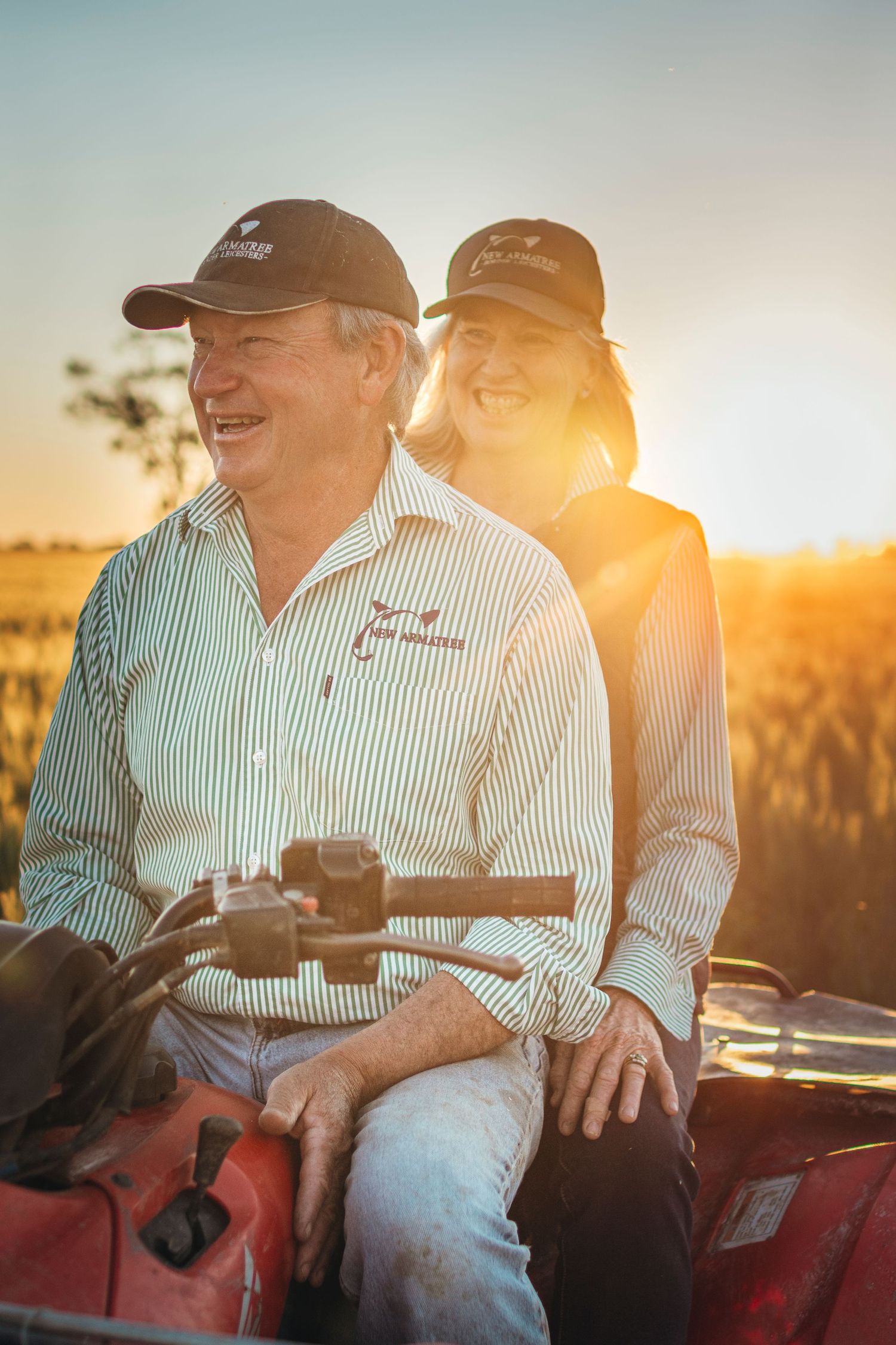 FARMERS ON A QUAD BIKE IN A WHEAT CROP WITH THE GOLDEN SUNSET IN THE BACKGROUND - NEW ARMATREE BORDER LIECESTORS